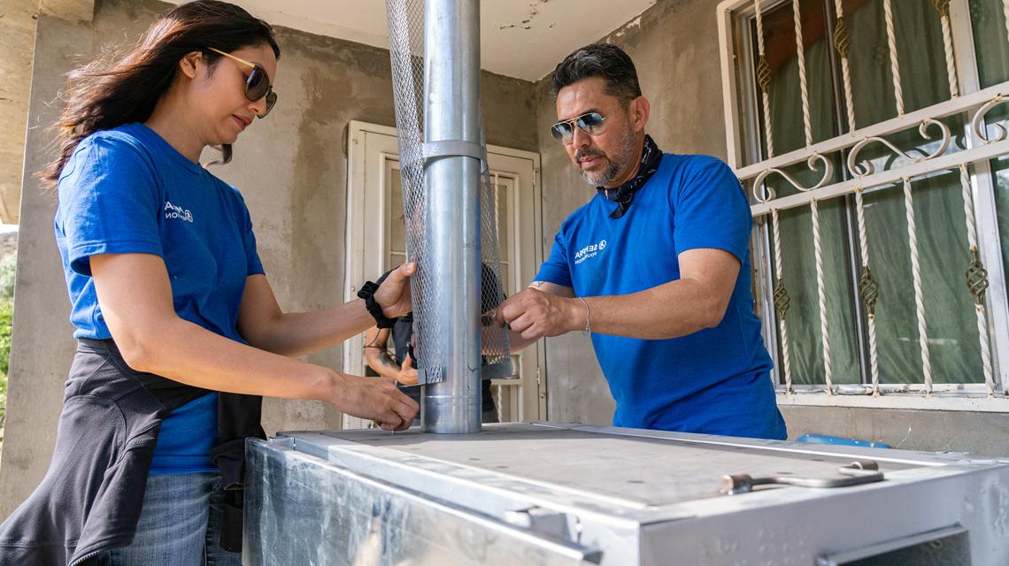 Sempra employees volunteer to assemble a clean-cooking stove for a family in Mexico